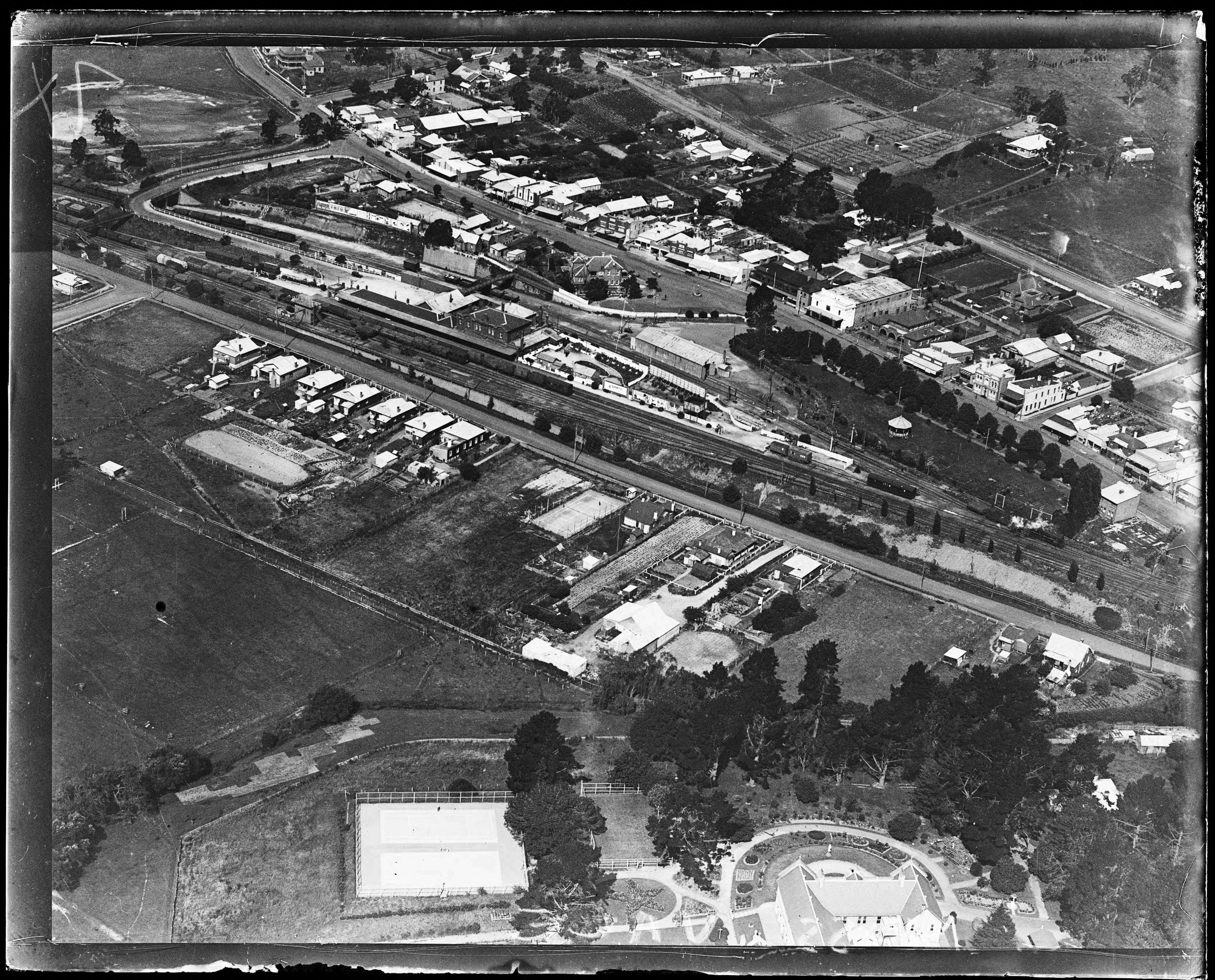 Oblique aerial photograph of Moss Vale station and Argyle Street around 1930