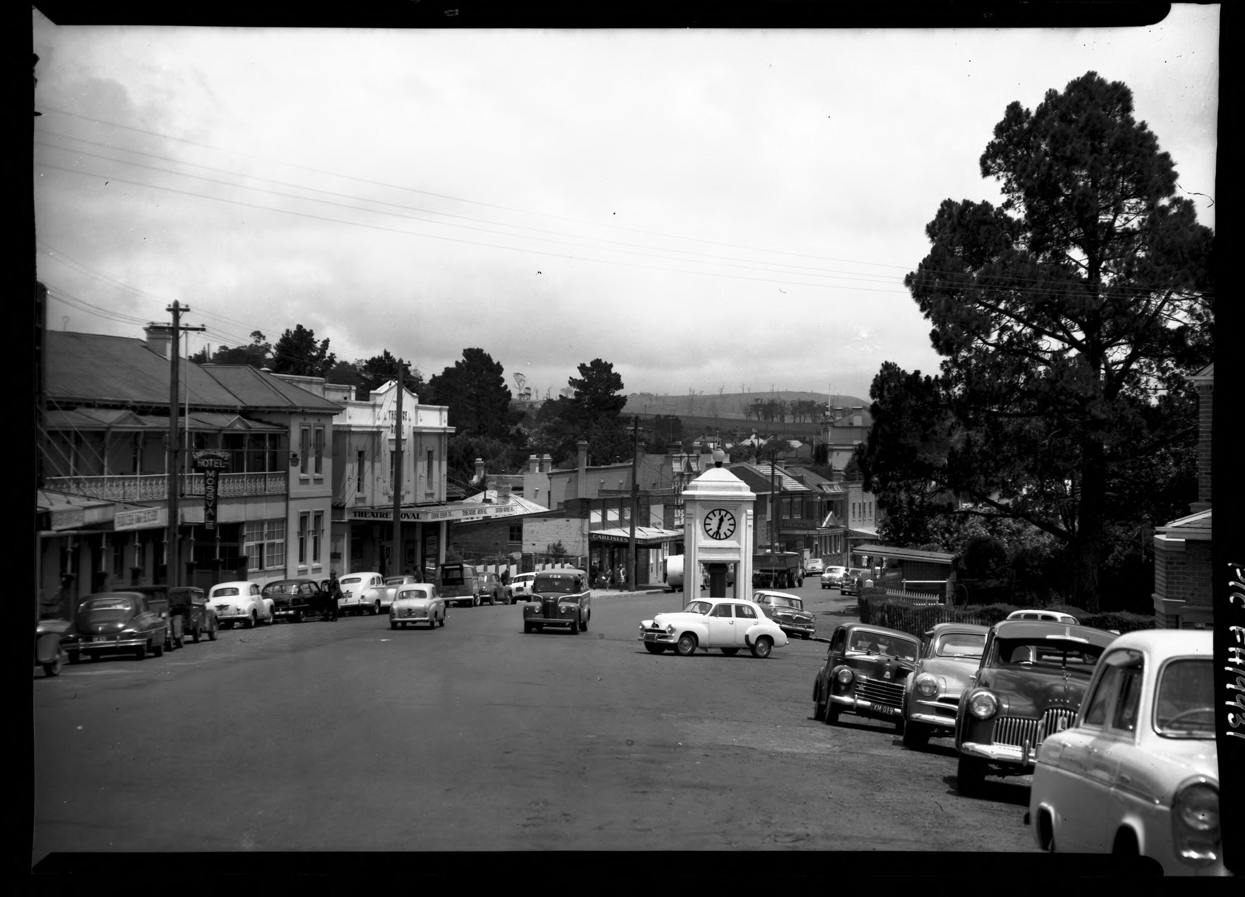 Frank Hurley's Moss Vale main street photograph with Theatre Royal, Carlisles, the clock and 1950s cars