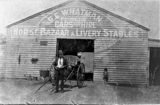 Edward Stanley Whatman outside the Central Motor Garage around 1918, with Phone 15 painted on its front